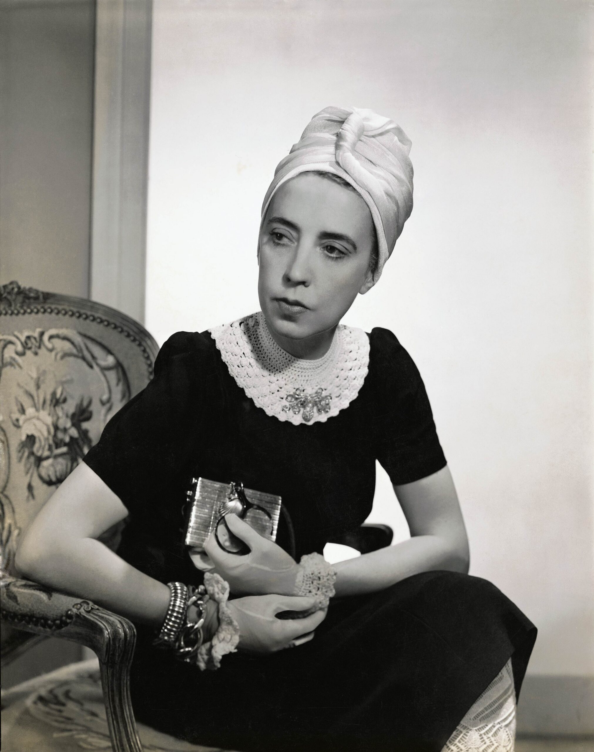 Vogue 1940 Designer Elsa Schiaparelli wearing black silk dress with crocheted collar of her own design and a turban Photo by Fredrich BakerConde Nast via Getty Images scaled